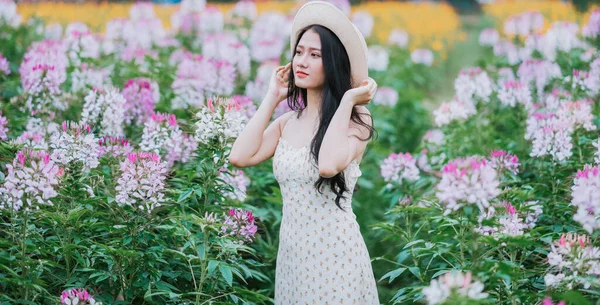Portrait of young Asian woman at flowers field