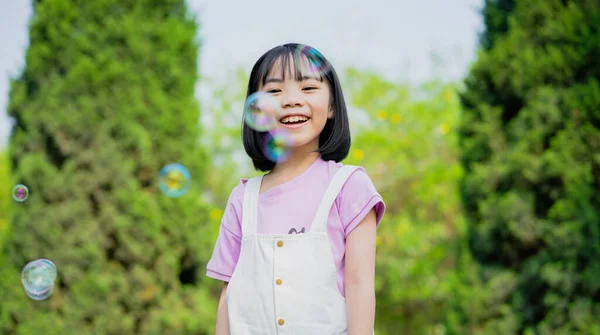 Image Asian Little Girl Playing Soap Bubbles Park — Foto Stock