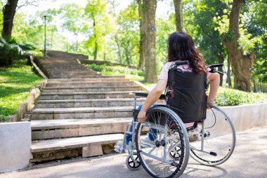 Image of middle-age Asian woman sitting on wheelchair
