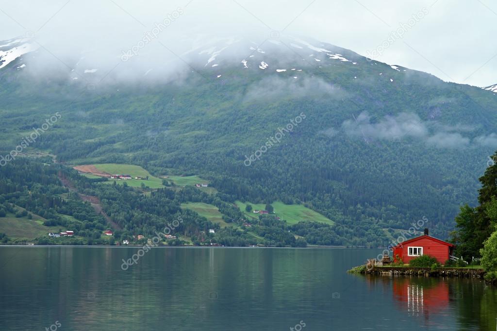 Red House reflection on a Norwegian fiord, Norway.