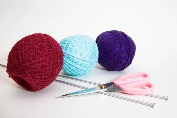 Three wool balls, knitting needles and scissors — Stock Photo, Image