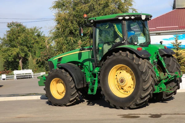 Tractor parked on the side of the road in the countryside. Agricultural machinery out of a place of work