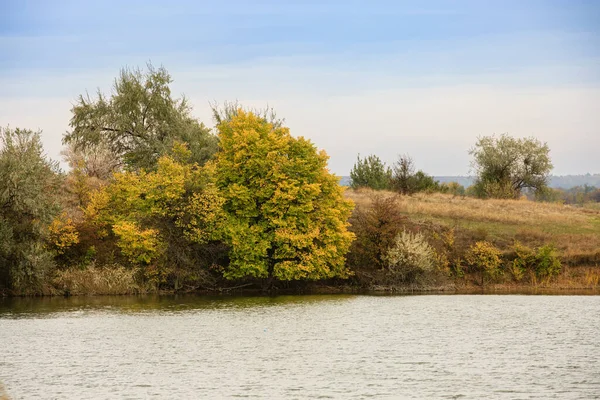 Landscape of a river or lake in the fall .Berga river with autumn colorful trees. Steppe autumn landscape.