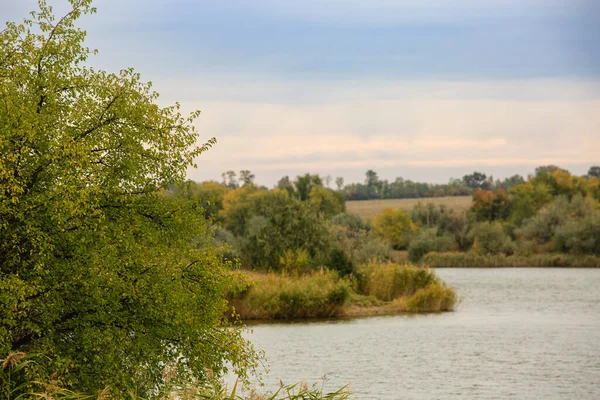 Landscape of a river or lake in the fall .Berga river with autumn colorful trees. Steppe autumn landscape.