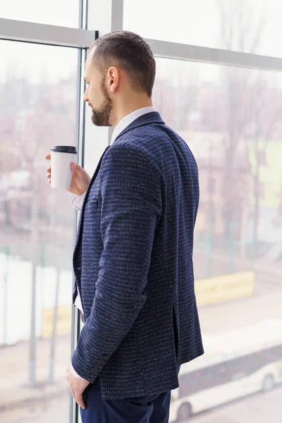 Young Man Business Suit Cup Coffee Stands Large Window Looks — Foto de Stock