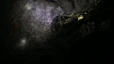 The process of drilling wells in an iron ore mine. Part of the technological process for mining minerals in an underground mine.