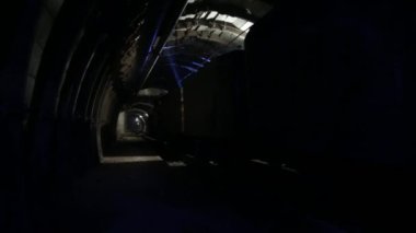 Movement of the train wagons in the mine tunnel. Technological equipment for mining underground, in the tunnel is poor lighting.