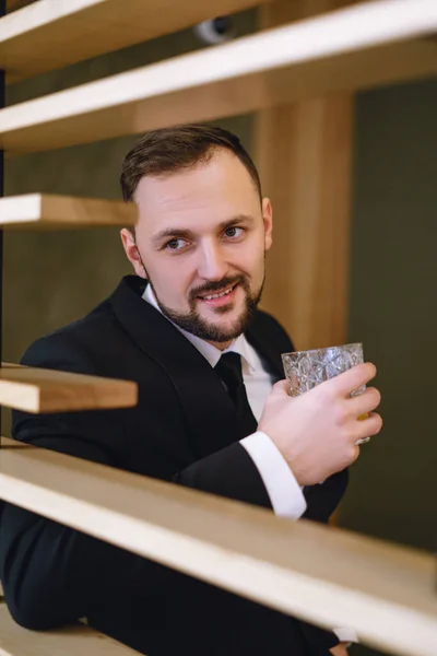 Young Man Beard Dressed Classic Business Suit Sitting Hands Glass — Photo