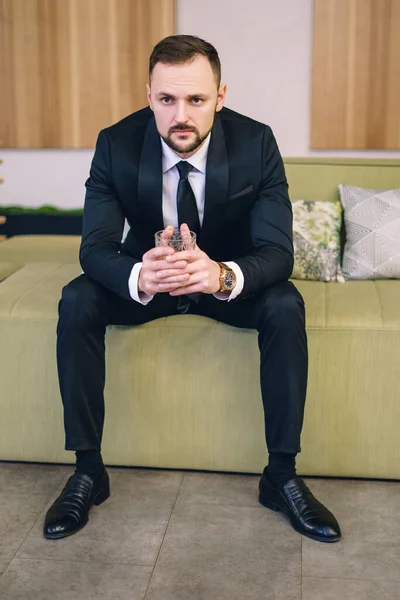 Young Man Beard Dressed Classic Business Suit Sitting Hands Glass — Photo
