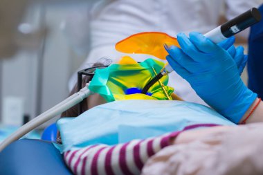 Dentistry. Little girl getting Inhalation Sedation while teeth treatment at dental clinic. Teeth treatment child.