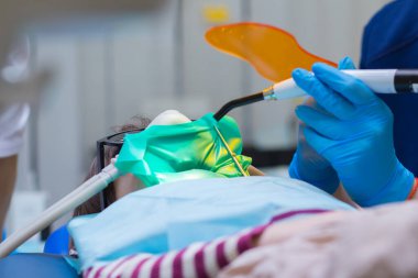 Dentistry. Little girl getting Inhalation Sedation while teeth treatment at dental clinic. Teeth treatment child.