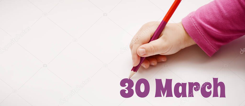 A child's hand writes 30 march in lilac pencil. Banner with copy space