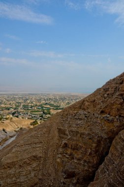 Günah dağlarından Jericho şehrinin manzarası. Dağların eteklerindeki antik ve sıcak şehir, dikey fotoğraf.