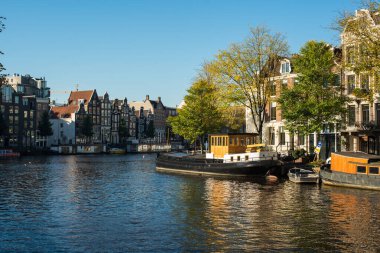 Amsterdam 'da tekneleri ve evleri olan bir kanal. 