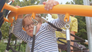 Gençler en üst platforma halat kullanarak tırmanır. Boş vakitte grup aktif oyun arkadaşları