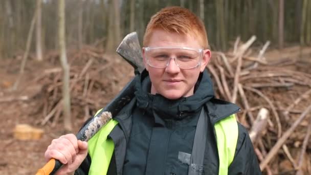 Portrait red-haired man in glasses with an ax in his handsSawmill worker — Stock Video