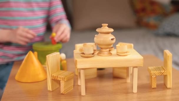 테이블에 있는 나무 장난감을 클로즈업합니다. 작은 테이블 과 의자, 탁자 위의 물건들. — 비디오