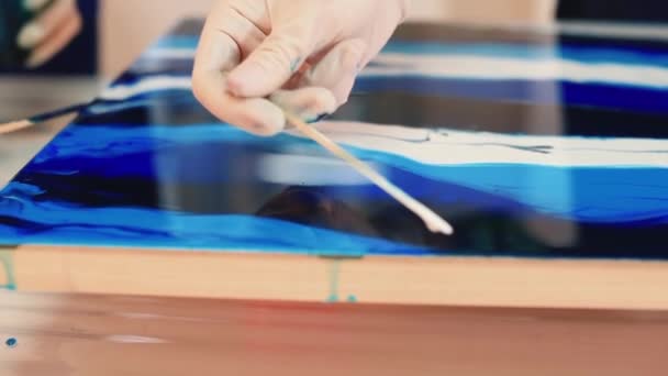 Artist hand makes stains paint with tool. Working with liquid paint hard surface — Stock Video