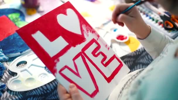 Maak een ansichtkaart met rode acrylverf, letters LOVE. Huwelijksvoorbereidingen. — Stockvideo