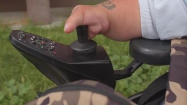 Engelli insan parmak basar tekerlekli sandalye joystick 'i hareket ettirir yol kenti 