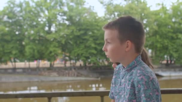 Dos adolescentes se están moviendo por la ciudad terraplén. Los transeúntes están en el bokeh. — Vídeos de Stock