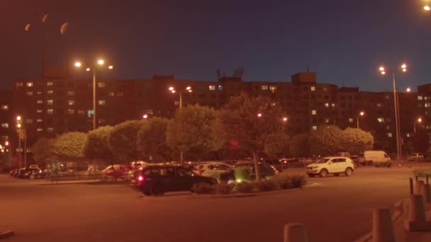 Parking evening city with flickering lights car slides into place. End day — Stock Video