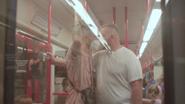 Zwei maskierte Männer hinter einem gläsernen U-Bahn-Zug. Personenbeförderung im öffentlichen Nahverkehr. — Stockvideo
