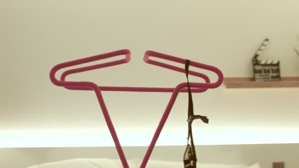 Woman hand threw her bra onto a red hanger place fold clothes before bed. — Stock Video