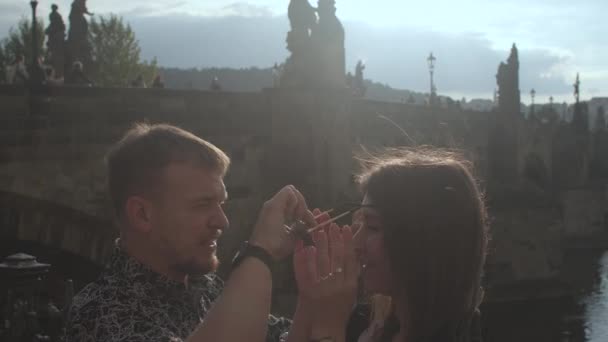 Man puts black glasses on womans eyes in sunny weather Courting girl — Vídeo de Stock