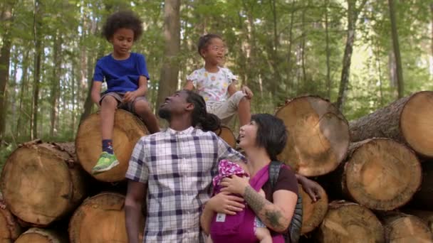 Portrait of woman and African American man with kids in park. Big family on walk — Stock Video