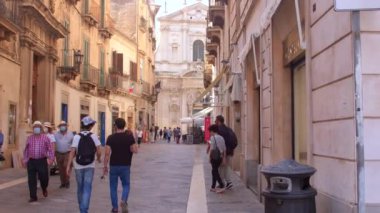 Masked tourists on streets of city. Impact of lockdowns on travel business