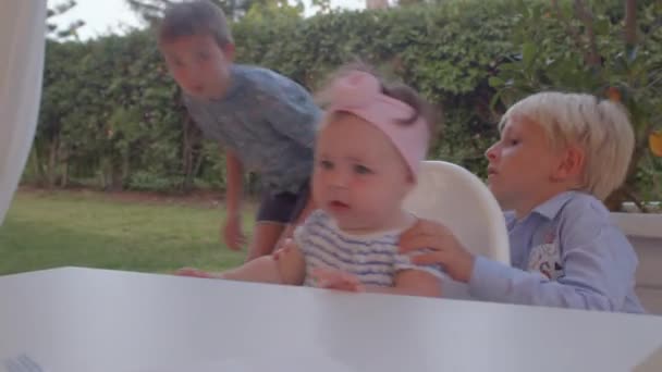 Boy tries to calm down sister who needs attention Child is screaming and nervous — Stock videók