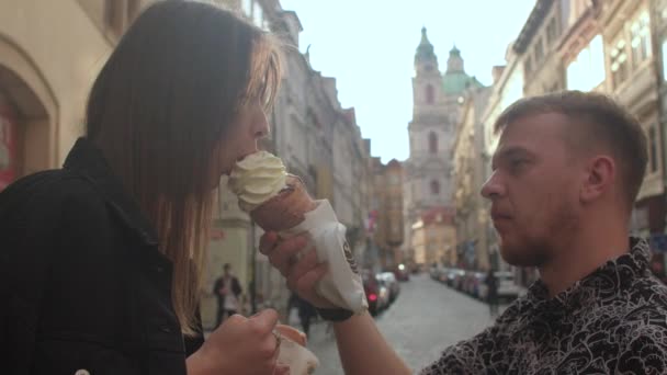 Lui le nutre il gelato. Tende un corno con la mano, la ragazza morde. — Video Stock