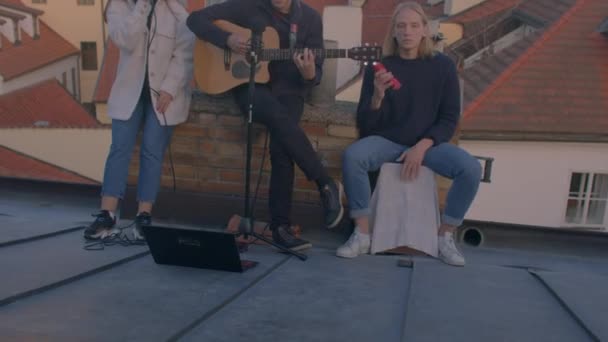 Jovem equipe talentosa toca música no telhado. Eles criam produto criativo. — Vídeo de Stock