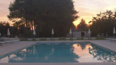 Sakin ol sıcak gün. Katlanmış şemsiyeler su yansıtıyor. Turistleri ağırlamak istiyoruz.