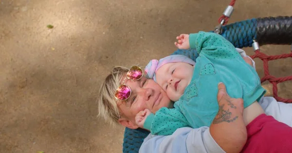 장애가 있는 여성 이 아기 랑 그네를 타고 있어요. 자녀와 부모. — 스톡 사진