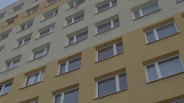Ventanas de un edificio de apartamentos. Fachada amarilla. Espacio para albergar población. — Vídeo de stock