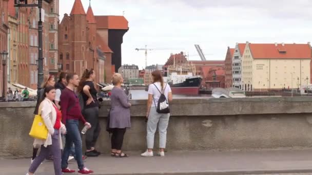 Idle touristes marchent le long du remblai, effectuer une excursion d'architecture urbaine. — Video