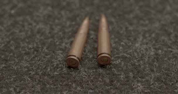 Live cartridges 7.62 with bullet lie on table. Whole capsule. Ready to shoot. — Stock Video