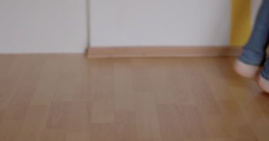 Bare children feet make dance move floor. He drags foot across floor step motion