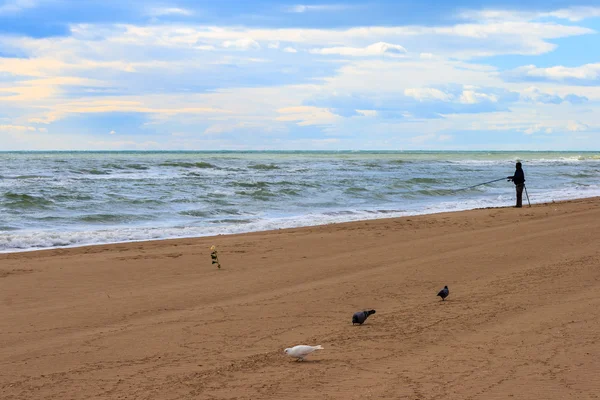 Fisherman on the beach — Stock Photo, Image