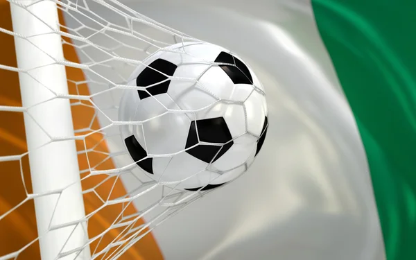 Drapeau de la Côte d'Ivoire et ballon de football en filet de but — Photo