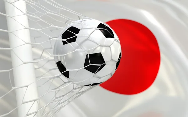 Japan wuivende vlag en voetbal in doel netto — Stockfoto