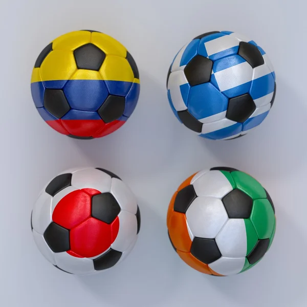 Balles de football avec drapeaux de Grèce, Japon, Côte d'Ivoire, Colombie — Photo