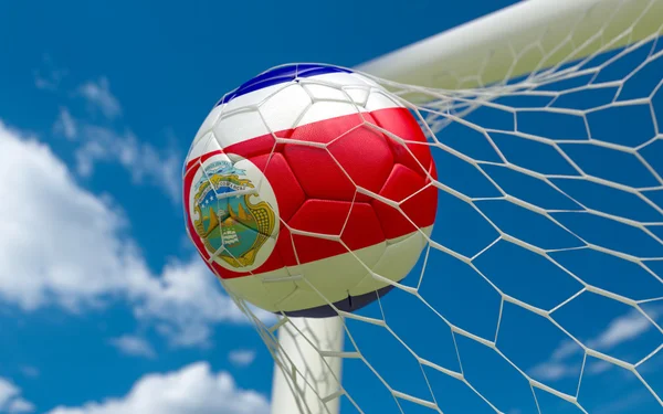 Costa Rica flag and soccer ball in goal net — Stock Photo, Image