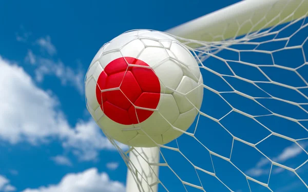 Bandeira do Japão e bola de futebol em gol líquido — Fotografia de Stock