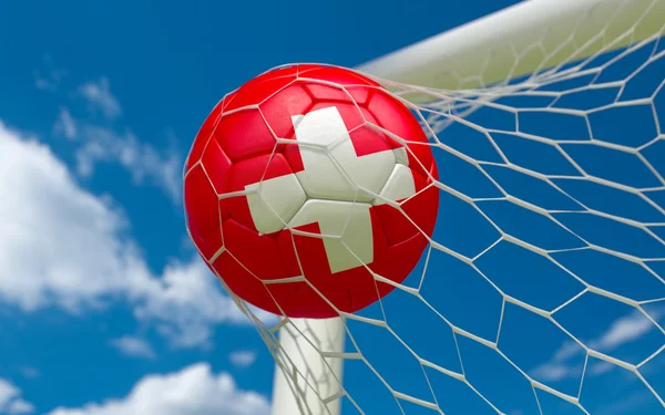 Bandeira da Suíça e bola de futebol em gol líquido — Fotografia de Stock