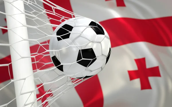 Drapeau de la Géorgie et ballon de football dans le filet de but — Photo