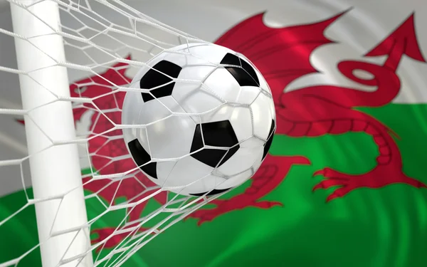 Flag of Wales and soccer ball in goal net — Stock Photo, Image