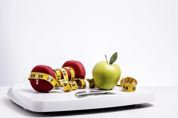 Green Apple & Freeweights Wrapped in a Tape Measure on a Scale — Stock Photo, Image